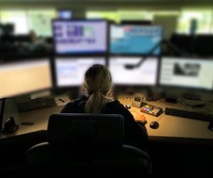 9-1-1 operator in front of screens