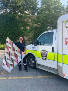 Middlesex-London paramedic holds up quilt outside ambulance
