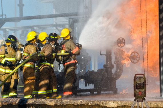 Firefighters in hazmat suits
